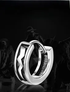 Detail of hip hop earrings with lightning patterns and oxidized black contrast finish