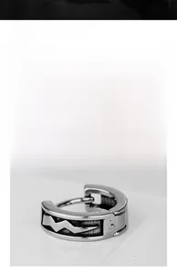 Close-up of vintage steel huggie earring featuring a unique lightning bolt design