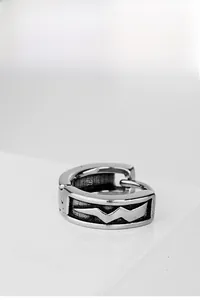 Detailed view of vintage titanium steel hoop earring with engraved lightning patterns