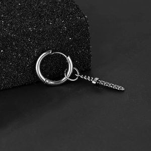 Minimalist stainless steel sword drop earring with woven texture on a dark stone background