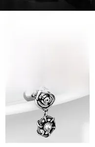 Détails macro de boucles d'oreilles rose en acier avec pendentifs en cristal