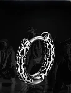 Detailed macro shot of vintage engraved silver steel hoop earring with hip-hop style patterns