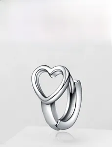 Polished silver heart-shaped hoop earring on a white geometric platform display