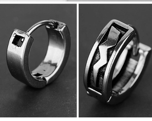 Detail of punk style titanium steel earrings featuring lightning bolt engraved patterns