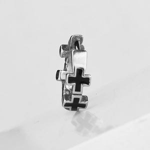 Minimalist silver huggie hoop earrings featuring black enamel gothic cross patterns