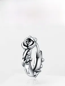 Detailed view of silver vintage rose stud earring with realistic floral embossed texture