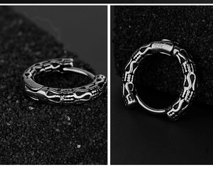 Detailed macro view of vintage stainless steel hoop earring with gothic relief texture