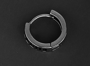 Vue détaillée d'une boucle d'oreille en acier noir avec des rainures rectangulaires