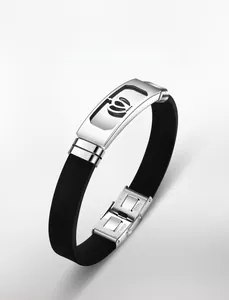 Detail of stainless steel buckle with crown cutout on black silicone sports bracelet