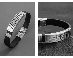 Macro view of men's black silicone bracelet with stainless steel geometric pattern plate
