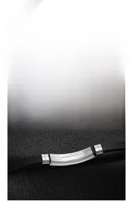 Detailed close-up of a men's silicone bracelet with a brushed stainless steel plate
