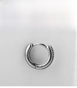 Macro detail of vintage oxidized silver huggie hoop earring with textured bead edge NO.06