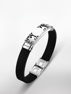 Detail of hollow geometric pattern on stainless steel and black silicone sports bracelet