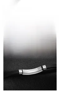 Detail view of black silicone strap with engraved stainless steel metal plate