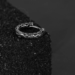 Minimalist stainless steel cross huggie earring with vintage engraved patterns on black stone