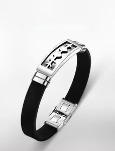 Detailed close-up of stainless steel clasp with engraved text on black silicone bracelet