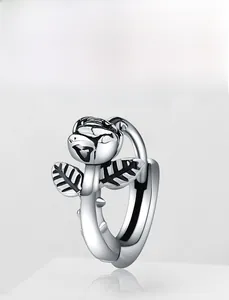 Macro view of 3D silver rose flower earrings with textured leaves and polished C-hoop