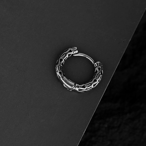 Gothic style stainless steel earring with intricate hollow patterns in vintage silver finish