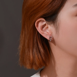 Minimalist silver heart earrings in polished stainless steel for a stylish daily look