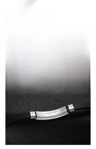 Macro detail of men's stainless steel bracelet with engraved material certification