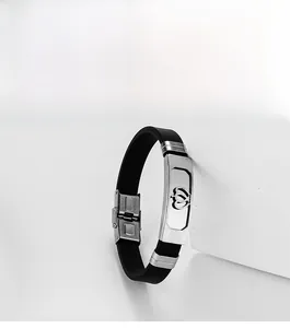 Detail of men's silicone bracelet with hollow crown stainless steel plate and clasp