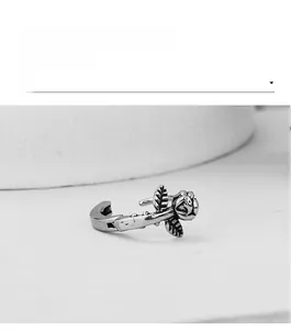 Macro shot of gothic rose flower ear cuff with vintage silver finish and thorn detail