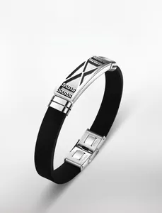 Detail of men's hollow stainless steel geometric X pattern and silicone bracelet