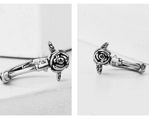 Detailed macro view showing the vintage 3D carved rose texture on steel earrings