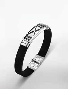 Close-up of stainless steel folding clasp with engraved text on black silicone strap