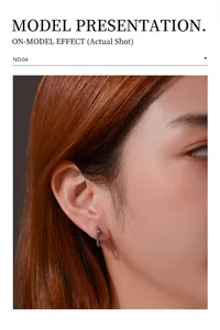 Macro shot of silver dragon-inspired hoop earring on ear with snake-like texture