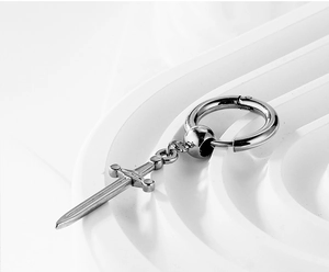 Detail of silver stainless steel hoop earring with a gothic sword pendant for men