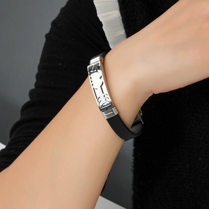 Hollow geometric stainless steel and black silicone bracelet for men on a wrist