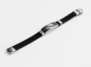 Close-up of men's black silicone bracelet with engraved stainless steel geometric pattern