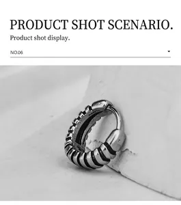 Detailed view of striped stainless steel hoop earrings with a vintage silver finish