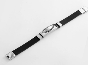 Detailed close-up of men's black silicone bracelet with stainless steel Greek key pattern