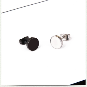 Detail view of round punk rock stud earrings in black and silver stainless steel