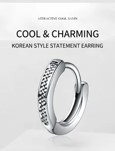 Detail of silver stainless steel hoop earrings with unique hammered texture and cool style