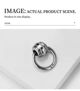 Gros plan d'un anneau de boucle d'oreille en acier avec perle texturée style vintage