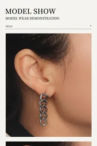 Detail of silver chain drop earrings in stainless steel on model ear showing drop length