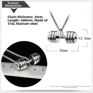 Macro shot of a stainless steel dumbbell pendant next to a ruler showing its 36mm size