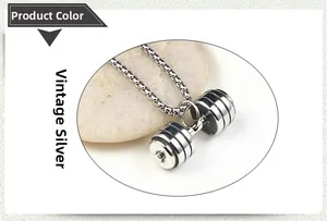 Detail view of retro silver dumbbell pendant on smooth stones with matte metal finish