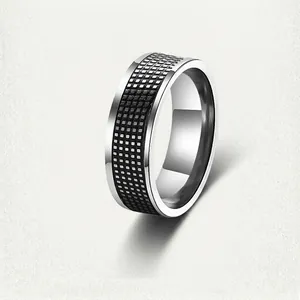 Detailed macro view of men's steel ring with black mesh texture and polished finish
