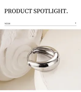 Macro shot of silver polished metallic hoop earrings with a secure hinge closure