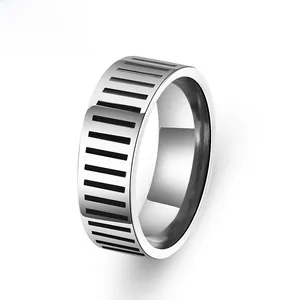 Macro shot of wide stainless steel ring with black industrial stripe pattern