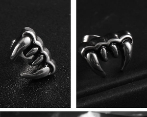 Vista macro di orecchini punk in acciaio inossidabile nero fumo con design a zanna lucida