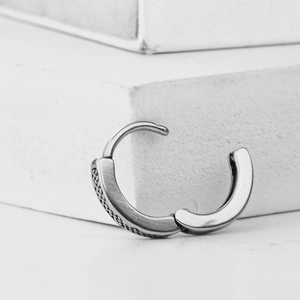 Minimalist silver stainless steel huggie earrings with woven texture and brushed metal finish