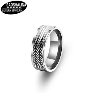 Macro detail of men's stainless steel ring featuring vintage vine leaf pattern texture