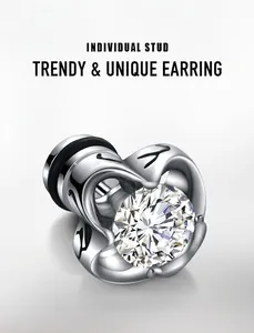 Macro shot of silver titanium steel stud earring with black flame pattern and clear zircon