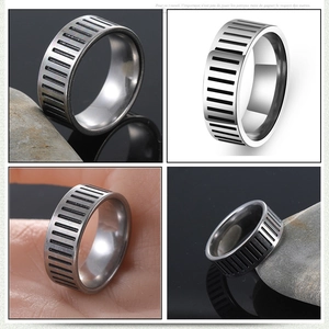 Detail view of silver stainless steel ring with vertical grooves and industrial design