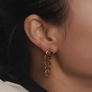 Minimalist gold Cuban link chain earrings in stainless steel on a female model